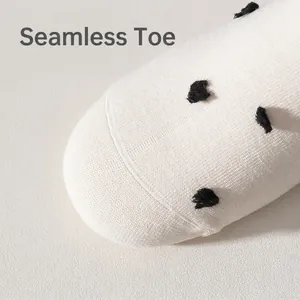 Polka dot white crew socks in combed cotton featuring seamless toe design