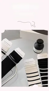 Detail of ribbed texture cotton crew socks in black, white, and striped patterns