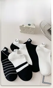 Detail of cartoon panda embroidery on low-cut black and white striped cotton socks