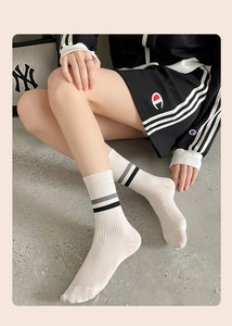 Detailed texture of white combed cotton ribbed crew socks with grey sporty stripes