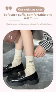 Detail of cream rib-knit mid-calf socks with lettuce edge and silver sequin bow
