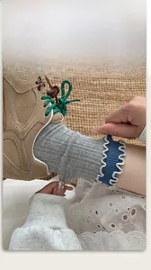 Close-up of grey cotton socks showing elastic blue wavy edges and ribbed texture details