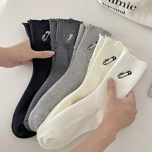 Five-pack of ribbed knit crew socks with safety pin embroidery and frayed edges
