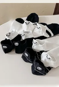 Close-up of cute panda embroidery on premium cotton black and white striped ankle socks