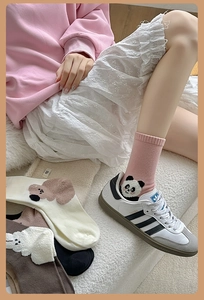 Detail of plush animal embroidery on soft cotton crew socks with ribbed cuffs