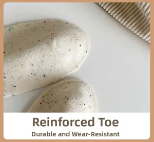 Close-up of reinforced toe on knit cotton socks with colorful speckled dot pattern