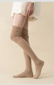 Close-up of khaki over-the-knee socks featuring a classic vertical ribbed knit texture