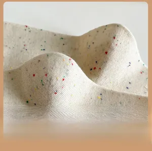 Macro shot of off-white ribbed knit socks with colorful speckle yarn texture