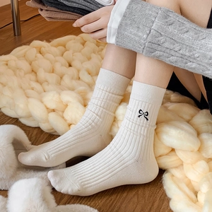 Women's cream white crew socks with ribbed texture and black bow embroidery detail