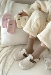 Detailed view of thick winter plush socks featuring cute cat and fish embroidery details