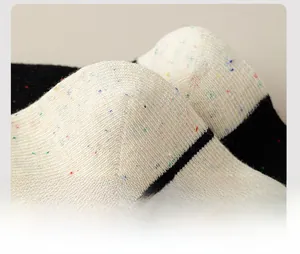 Detail of reinforced heel on speckled knit cotton socks with black stripe pattern