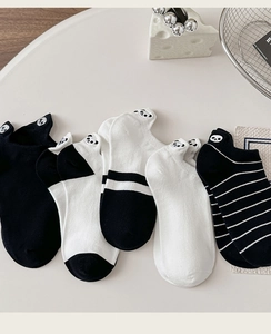 Close-up of cute panda embroidery on low-cut cotton socks with black and white designs