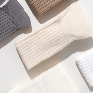 Over-the-knee cotton ribbed socks in dark grey, camel, beige, and white colors