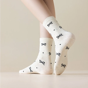 Bow pattern crew socks in off-white confetti yarn with comfortable ribbed cuffs
