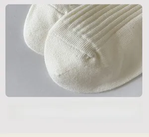Detail of flat seam toe and vertical knit texture on white cotton crew socks