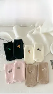 Detail of warm winter socks with cute animal embroidery and thick fuzzy thermal fabric