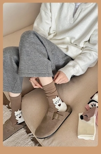 Detailed knit texture of khaki cotton socks featuring cute white bear and animal patterns