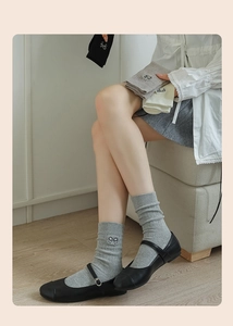 Detail of embroidered black bows on ribbed cotton mid-calf socks for women