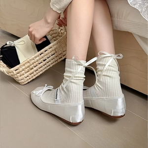 White knit ribbed socks paired with satin bow ballet flats in a soft aesthetic style