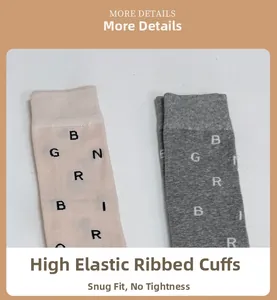 Close-up of high elastic ribbed cuffs and letter patterns on pink and grey mid-calf socks