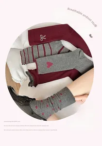 Detail of crew socks with bow embroidery, striped patterns, and heart designs