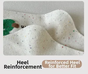 Close-up of cream knit socks with colorful speckles and reinforced toe and heel