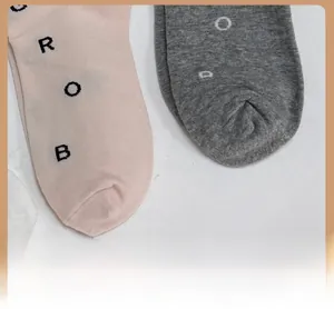 Detailed close-up of reinforced toes on cotton blend mid-calf socks with letter knit