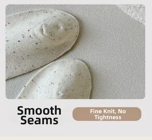 Detailed macro view of flat-seamed toes on cream speckled knit cotton socks