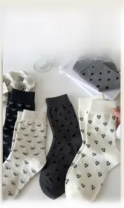Close-up of cotton socks set featuring bow knots and heart patterns in various colors
