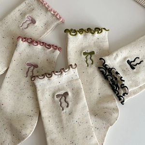 Chic knit crew socks with delicate bow embroidery and stylish ruffled cuffs for women