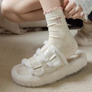 Plush beige platform sandals with buckle straps paired with bow embroidered socks
