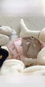 Close-up of cozy thickened winter socks with cute animal embroidery on soft fleece