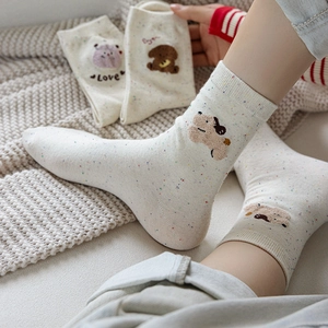 Cozy cream knit mid-calf socks with colorful flecks and cute animal embroidery