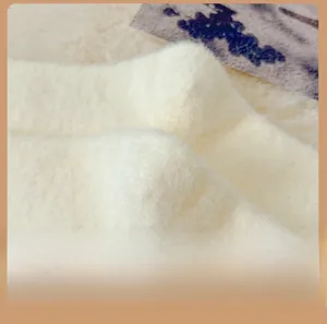 Detailed macro view of the fluffy white plush heel texture on cozy winter fleece socks