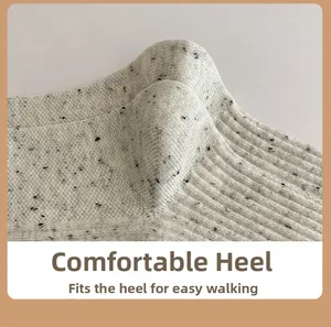 Detail view of the comfortable heel structure on light gray knitted flecked socks