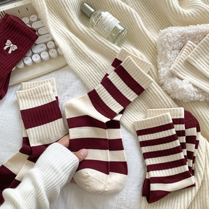 Knitted burgundy and cream striped mid-calf socks with white bow embroidery detail