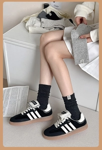 Detail of speckled knit crew socks featuring a square fabric label and soft cotton texture