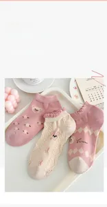Detail of sweet cotton socks featuring cute bear embroidery and floral patterns