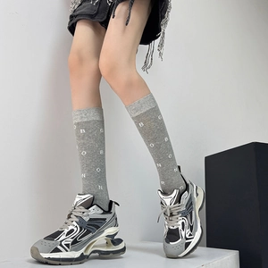 Chic women's grey lettered calf socks paired with multi-layer chunky mesh sneakers