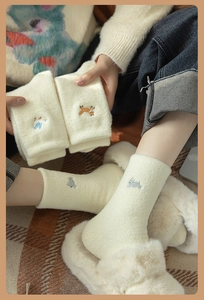 Detailed embroidery of cute animals on warm white plush socks for home comfort
