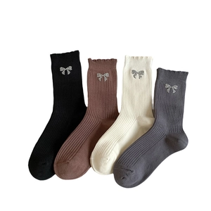 Women's rib-knit mid-calf socks with bow accents in black, coffee, beige, and grey colors