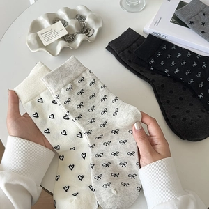 Women's cotton crew socks with heart and bow patterns in white, grey, and black colors