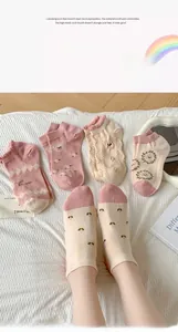 Detail of sweet pink cotton socks featuring cartoon bear embroidery and lace trim