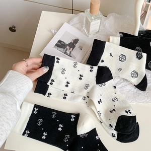 White cotton mid-calf socks for women featuring bow and camellia patterns in a gift set