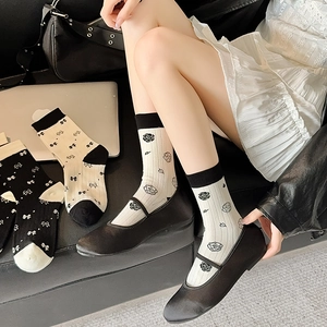 Women's white cotton mid-calf socks with black camellia floral and bowknot designs