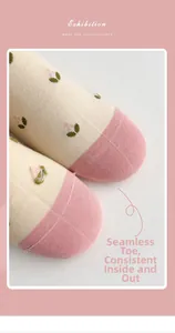 Detailed macro view of seamless toe stitching on beige cotton socks with pink floral pattern