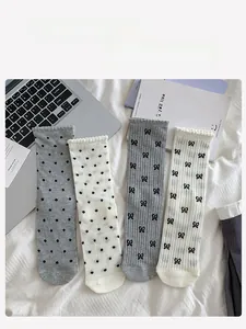 Detail of four pairs of women's Japanese style socks with bowknot and polka dot patterns