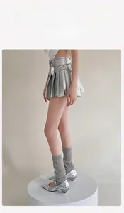 Detail showing shiny silver metallic pleated mini skirt with matching mary jane shoes