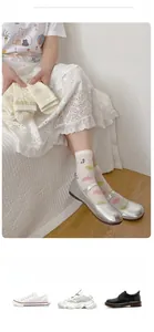 Detail of white mesh crew socks with colorful polka dots and cute smiley face patterns