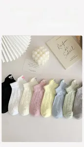 Detailed flat lay of 8-pack mesh socks with bow embroidery in various pastel colors